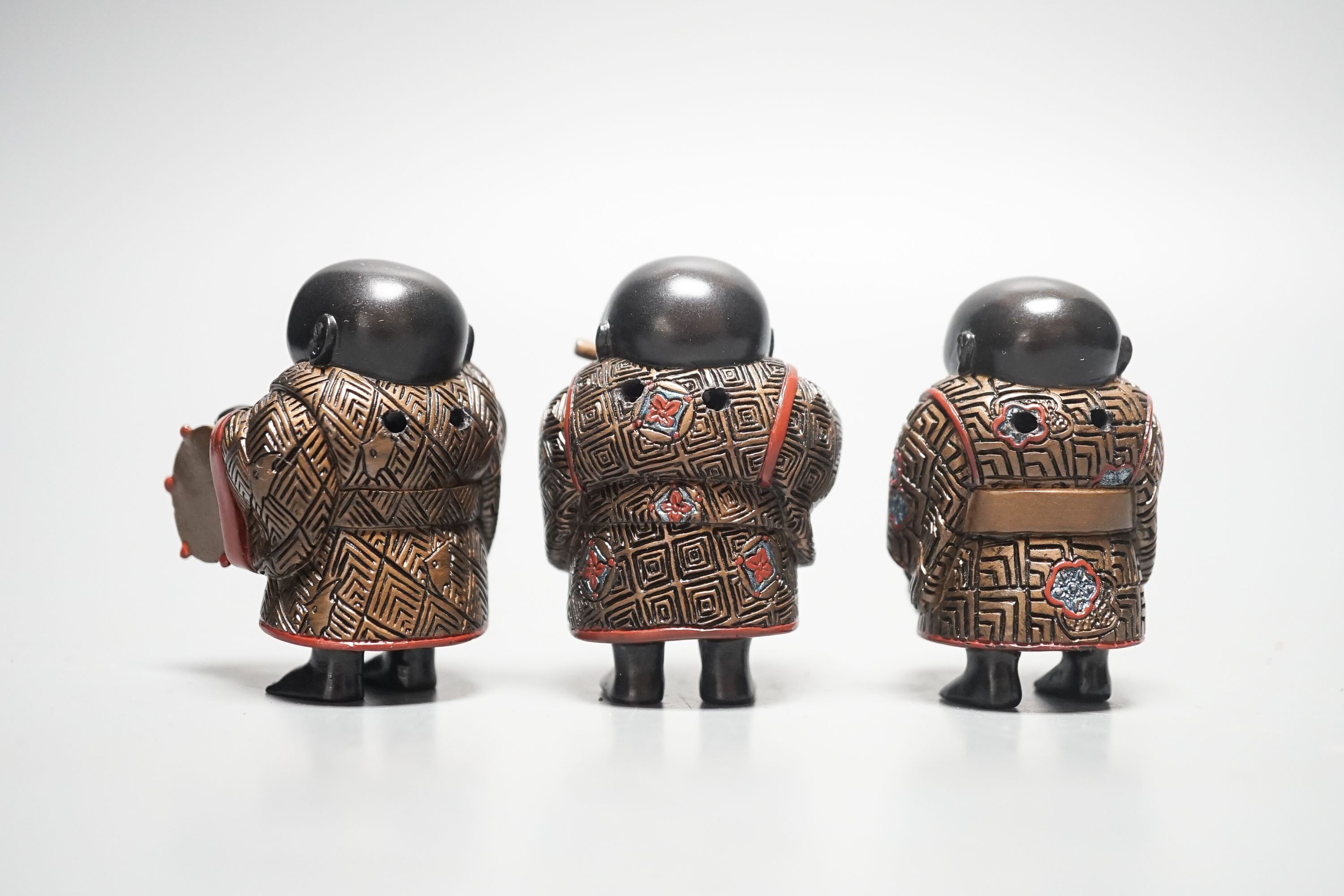 A set of three Japanese lacquered composition ‘musician’ netsuke, 6.5cm